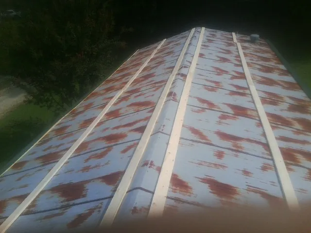 Rusted metal roof panels with new wood purlins before replacement — Storm Damage Roof Repair in Pleasant View by Roofing Brothers